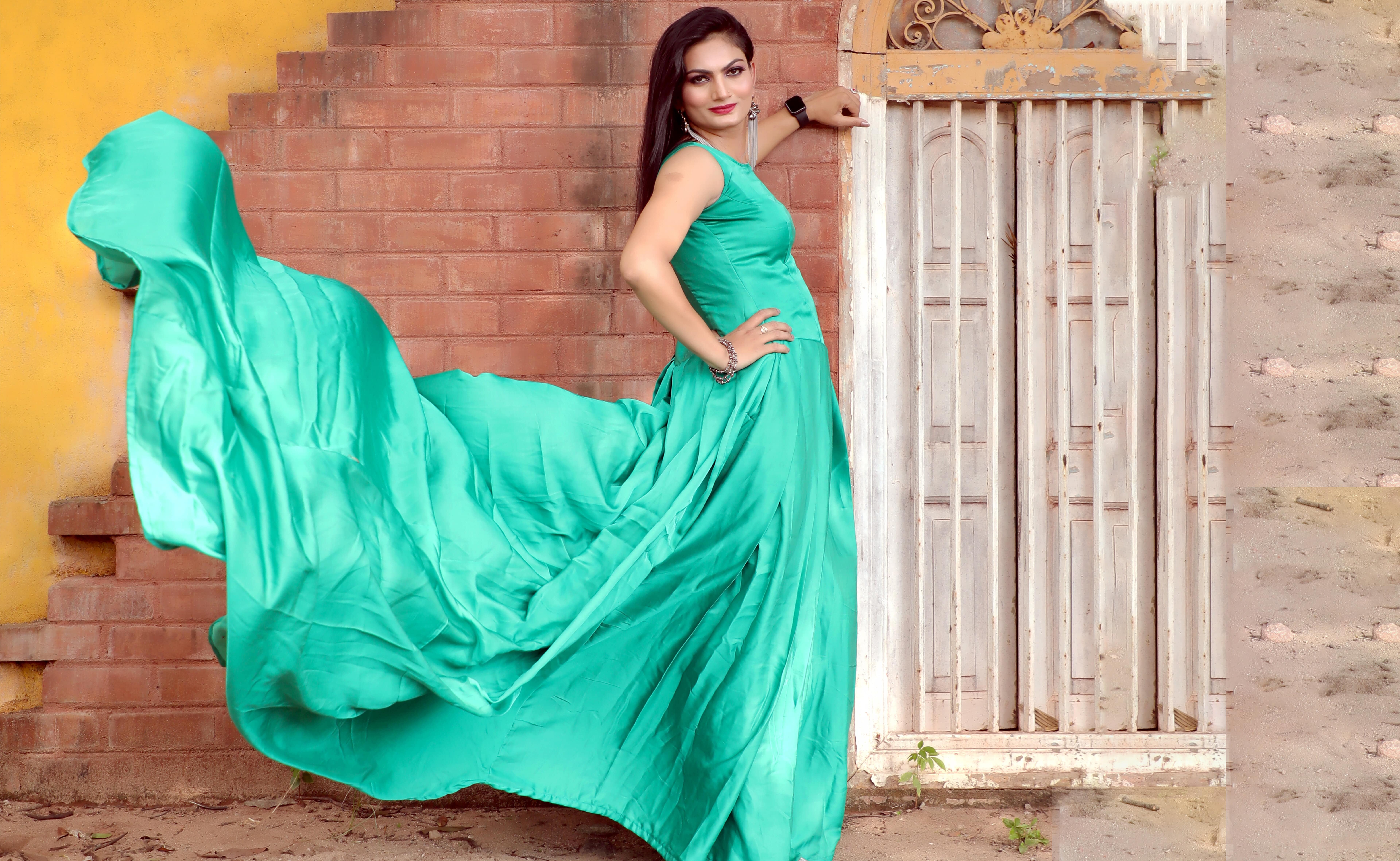 and an elegant forest green gown that complements her ethereal beauty. Soft  pretty face